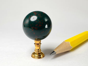 Polished bloodstone sphere on stand