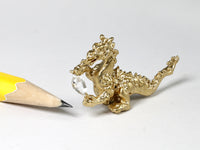 Miniature gold dragon with diamond quartz crystal