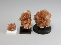 Side view, Three different sizes of aragonite crystal clusters on stands with a pencil for scale; dollhouse miniatures