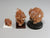 Side view, Three different sizes of aragonite crystal clusters on stands with a pencil for scale; dollhouse miniatures