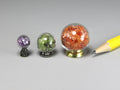 Glass orbs filled with real gem chips, sold individually.  Birthstones