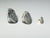Side view, Three trilobite fossils of different sizes, dollhouse specimens