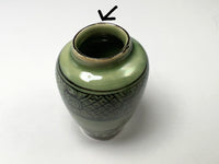 Repaired chip on rim of vase