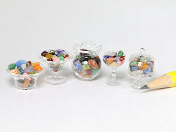 Polished semi-precious gems in glassware.  Sold individually