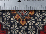 Back of rug with ruler for knot counting