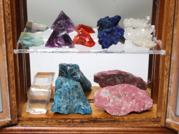 Lower two shelves of miniature mineral collection