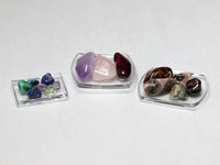 Polished gems on glass dishes, dollhouse accessories