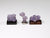 Other side of Three tiny specimens of purple grape agate