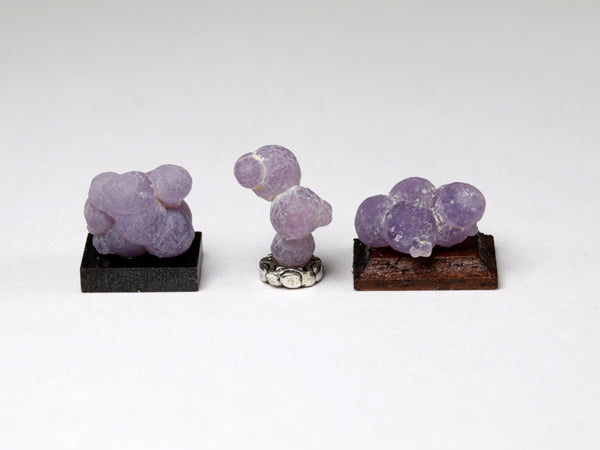 Other side of Three tiny specimens of purple grape agate